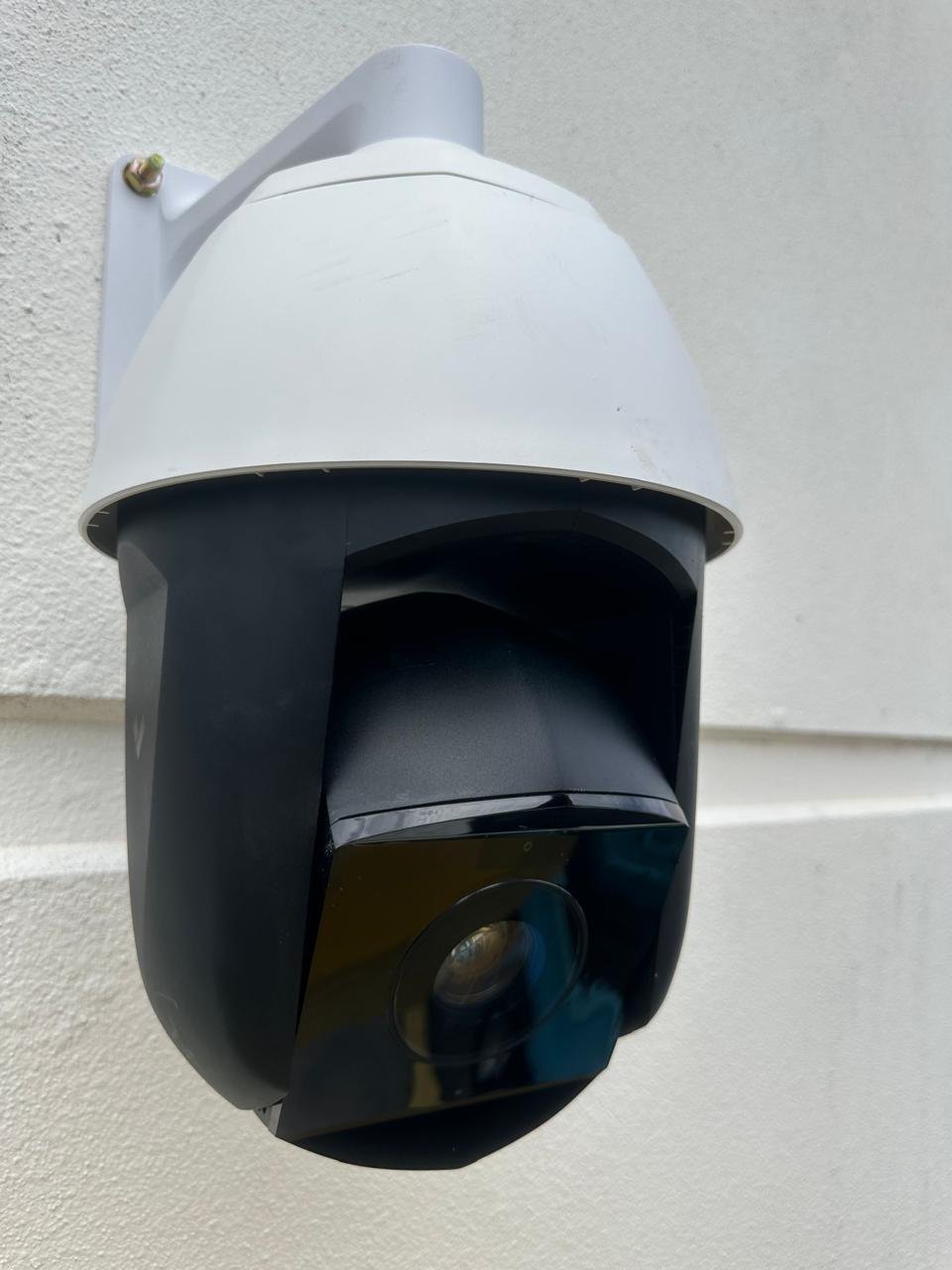 Close view of an installed exterior surveillance camera.