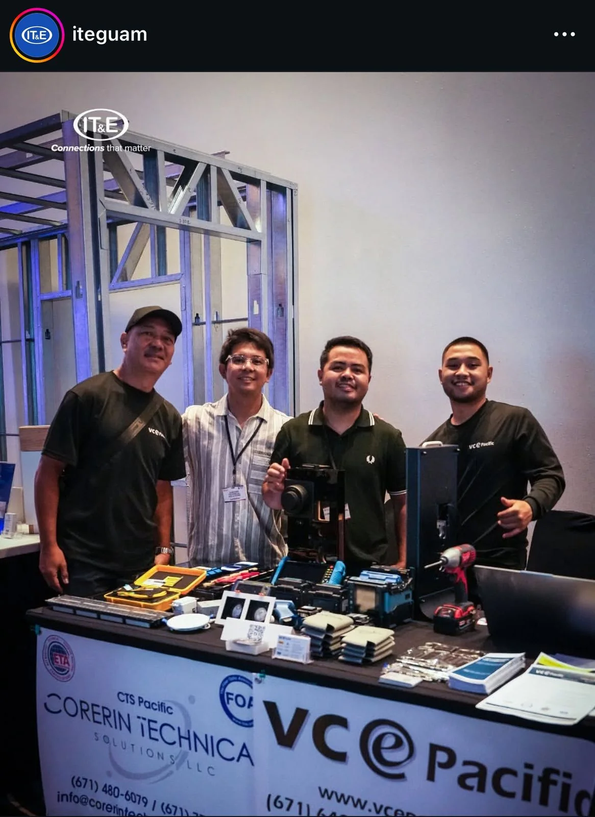 Group at an exhibition booth with CTS Pacific and VCE Pacific banners, in an IT&E social photograph.