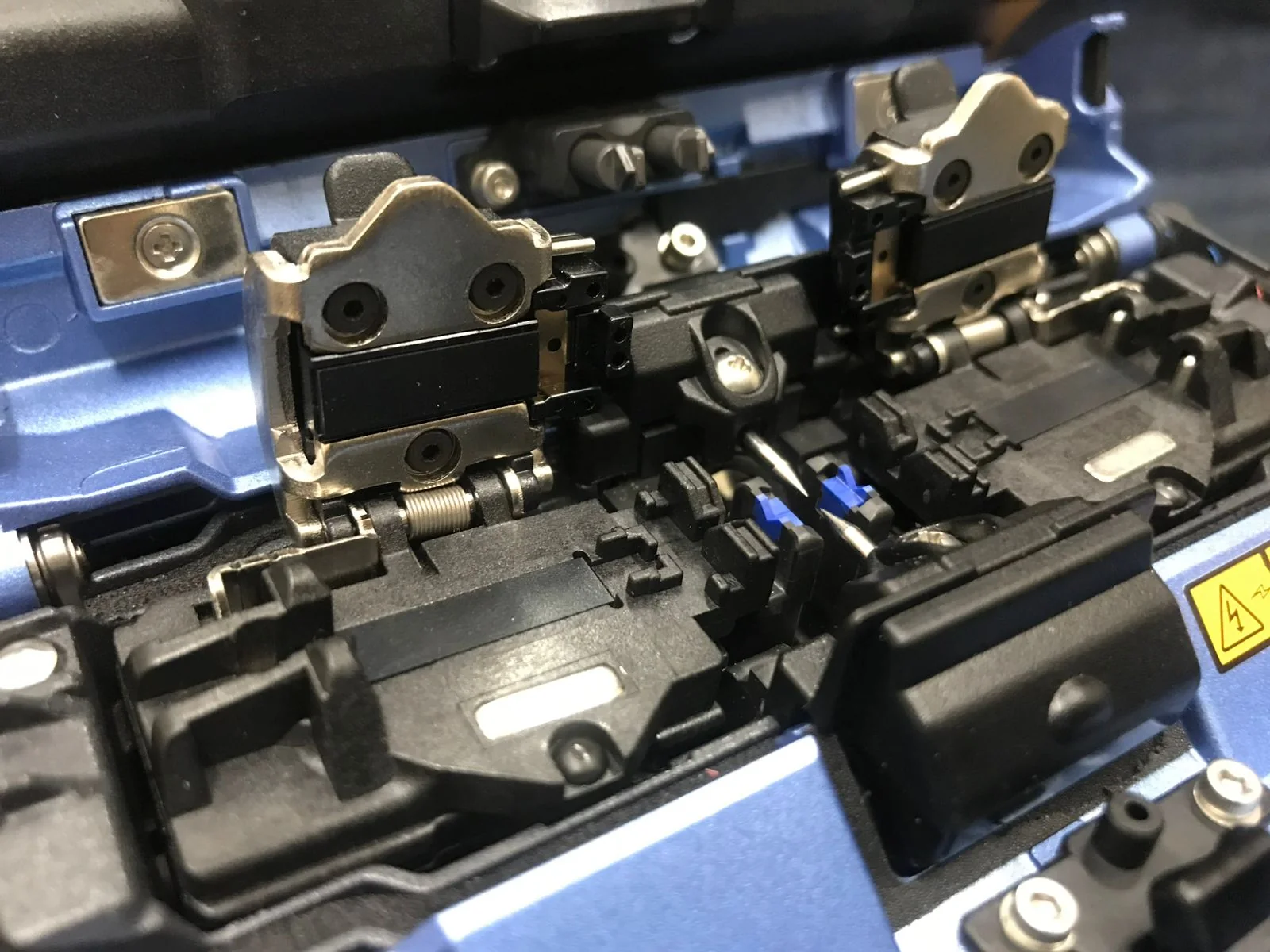 Fusion splicer with its fiber alignment clamps open.