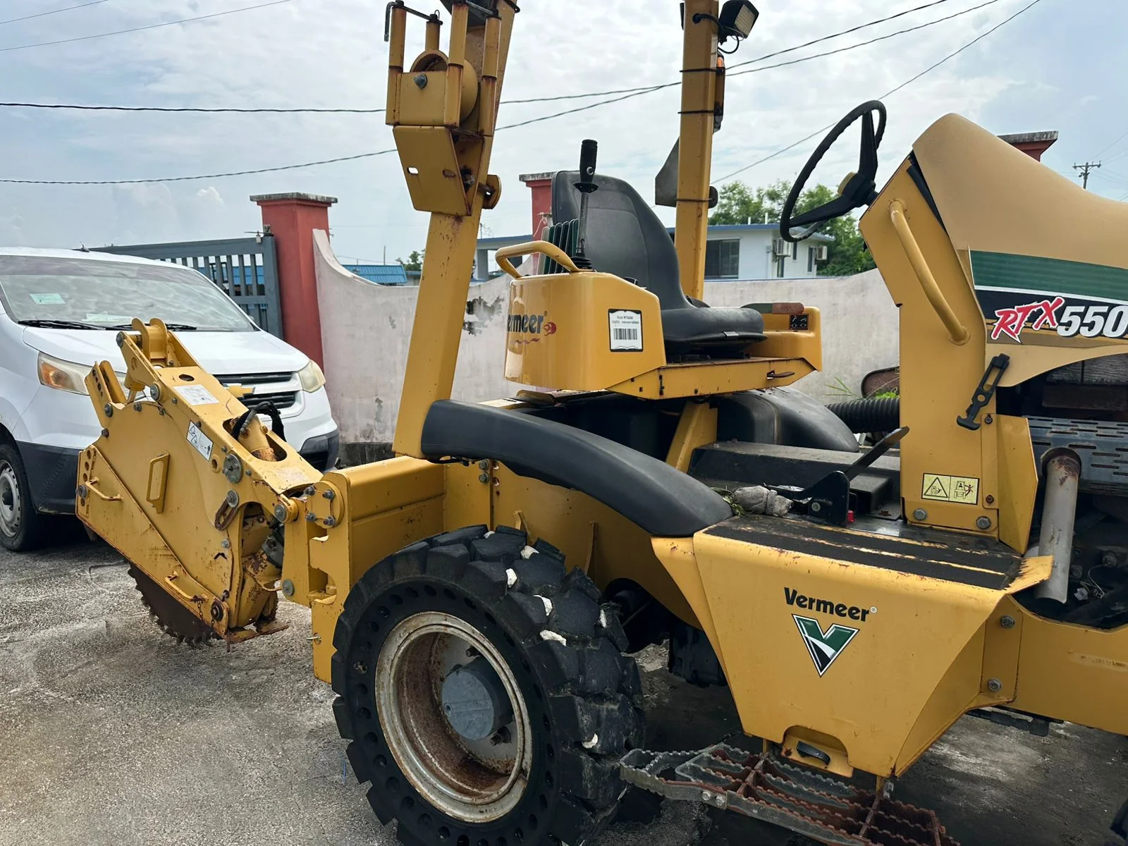 Side view of a yellow Vermeer RTX550 trencher outdoors.