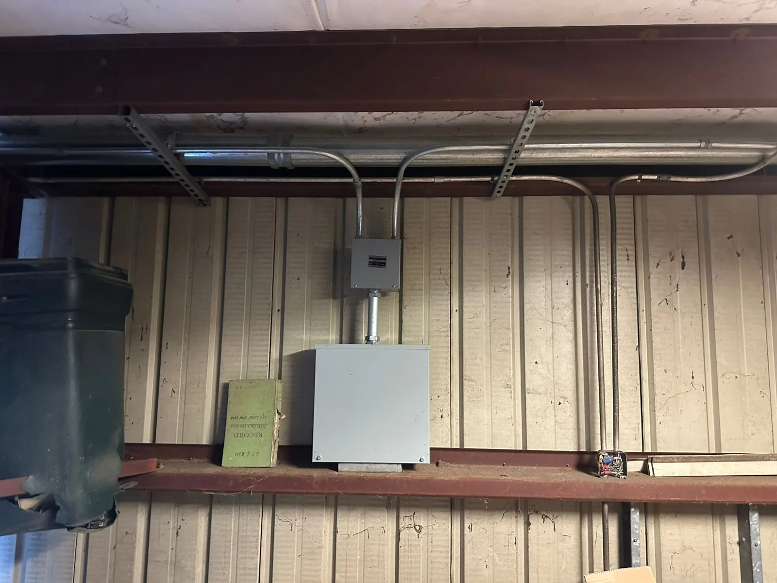 Wall-mounted gray junction boxes connected by metal conduit.