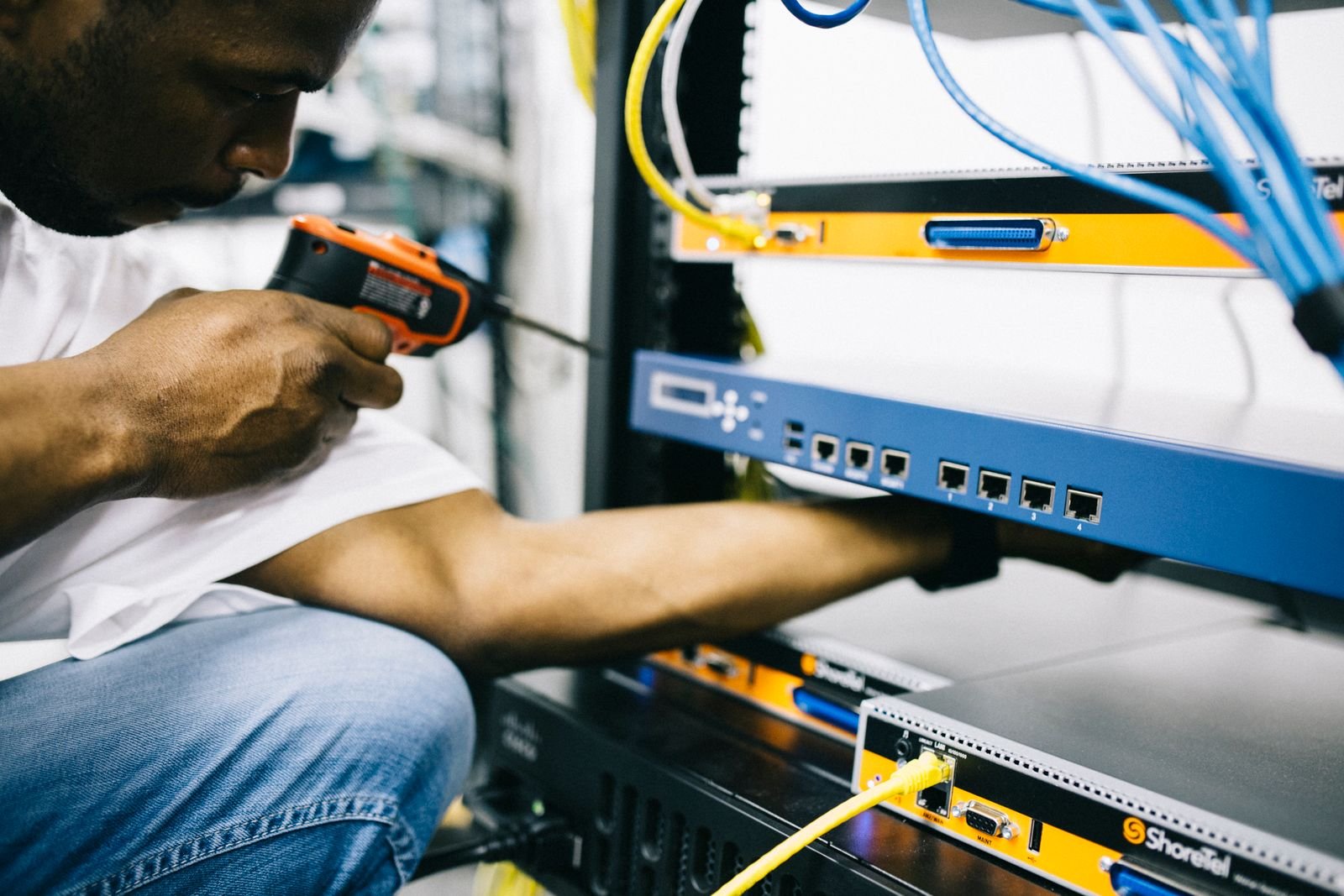 Technician maintaining installed network hardware.