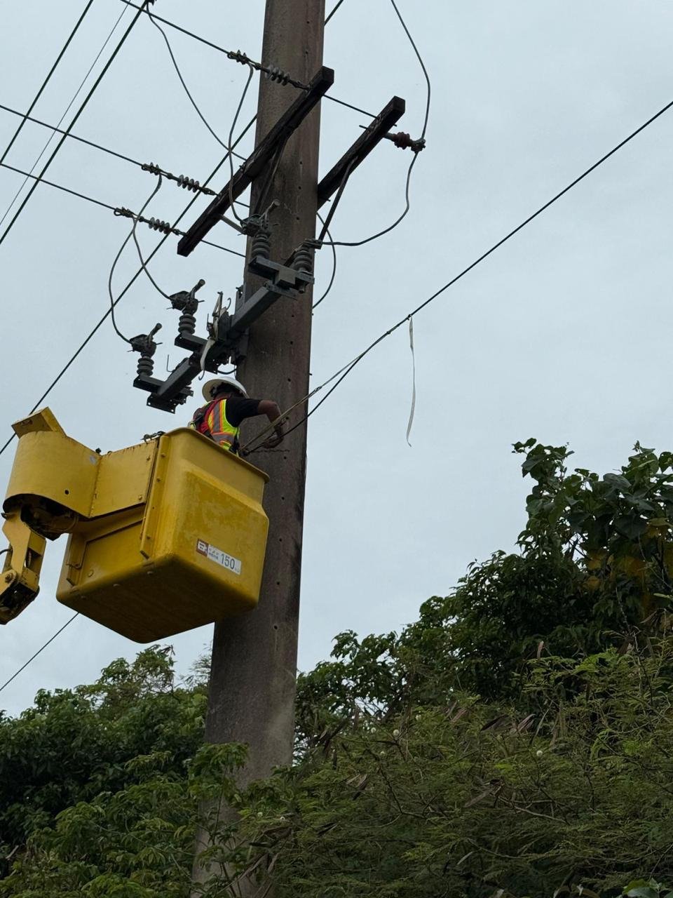 CTS Pacific technician performing elevated infrastructure field work from a bucket truck.