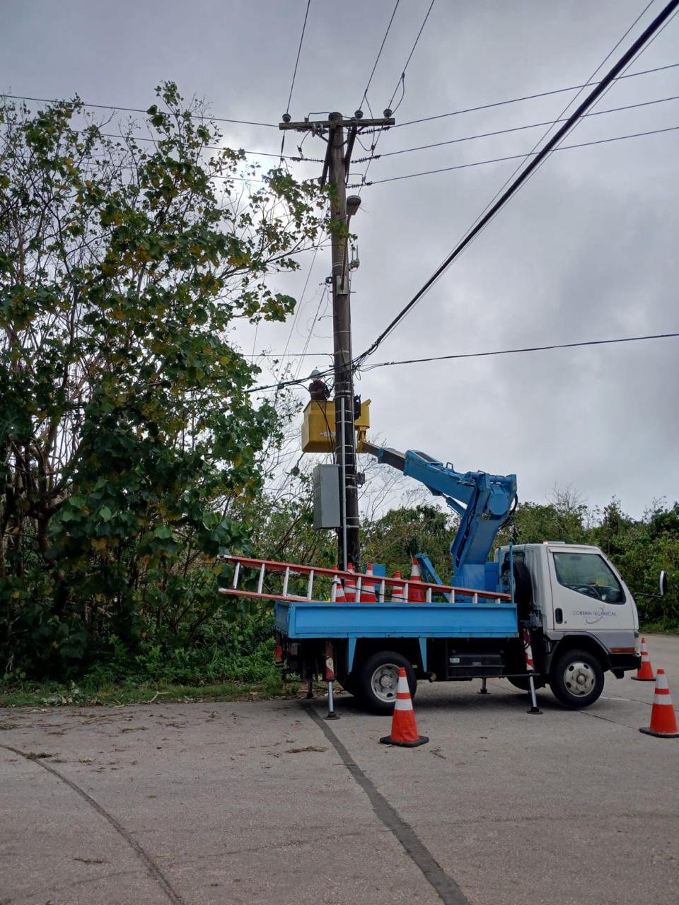 CTS Pacific field crew accessing elevated communications infrastructure.