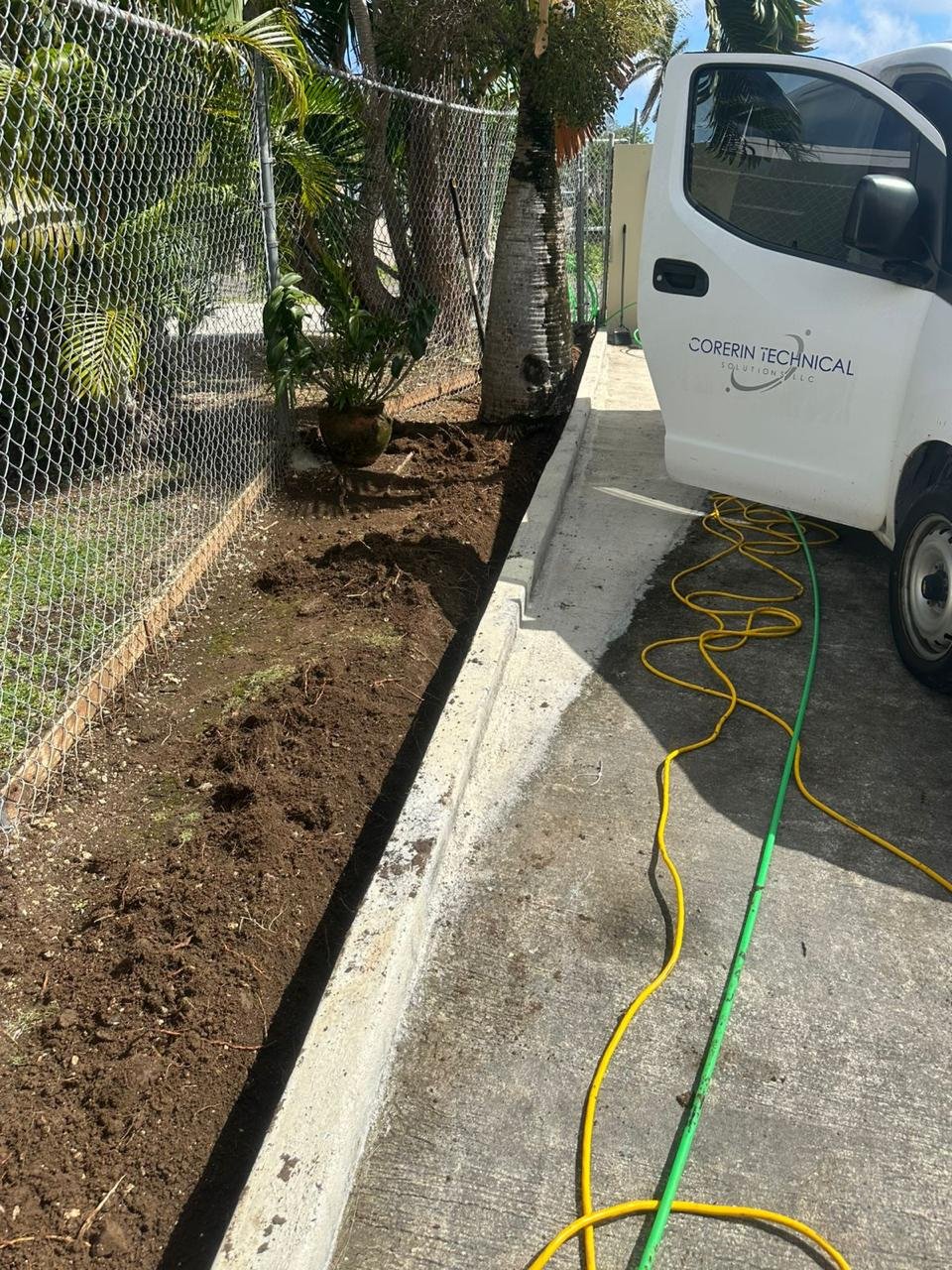 Excavated underground pathway beside a CTS Pacific service vehicle.
